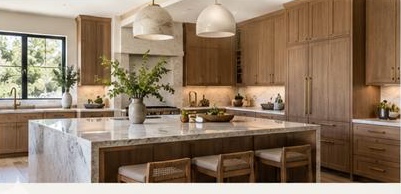 Kitchen with a marble island, oak cabinets, and a single pendant light